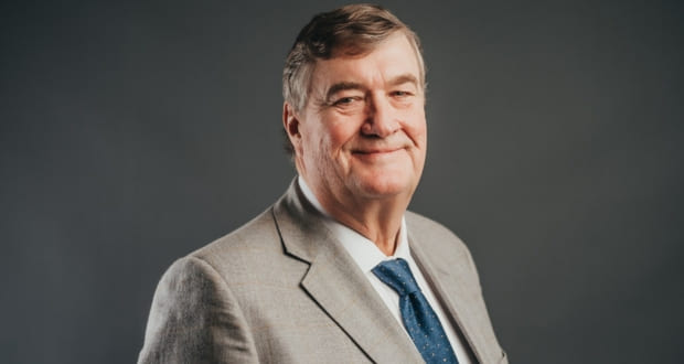 Studio portrait of Arnaud Dalais in a light grey suit